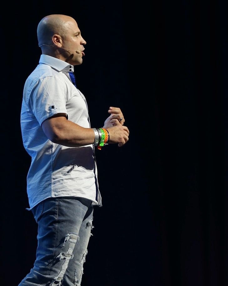 David Atkins speaking on stage at a national staffing and recruiting conference